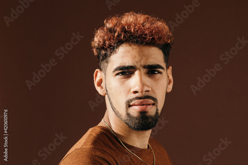 Pensive stylish Hispanic man in casual shirt