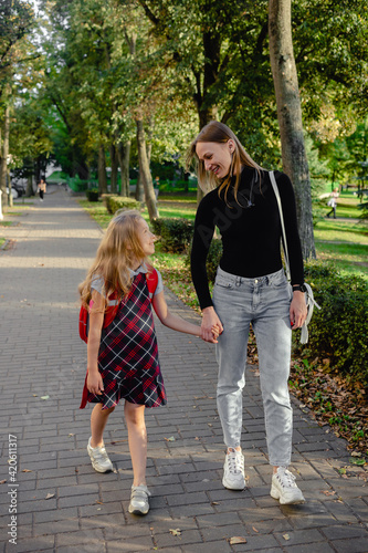 preschool girl walk with her mother
