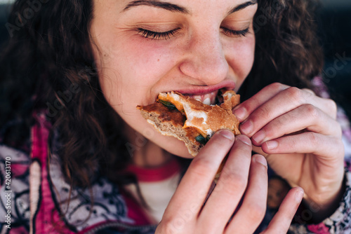 Teenager eating a hamburger photo