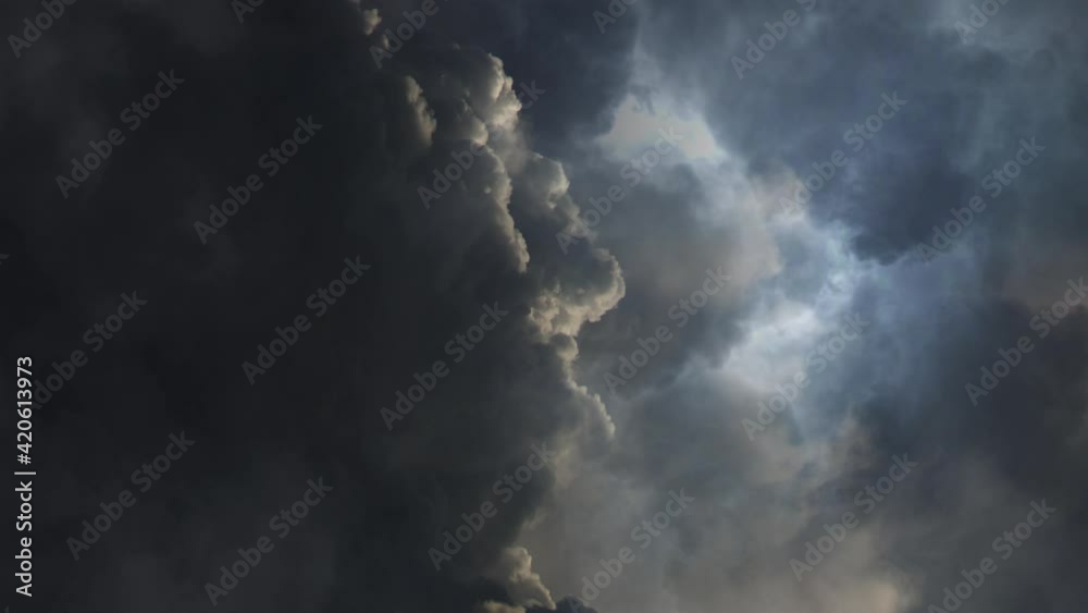 dark cumulonimbus clouds with thunderstorms raging inside