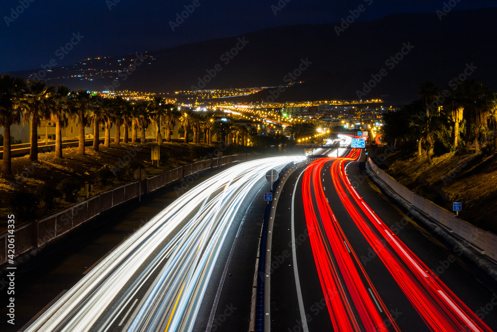 Stunning long exposure photo of the highway at night with the light trails of the cars.
