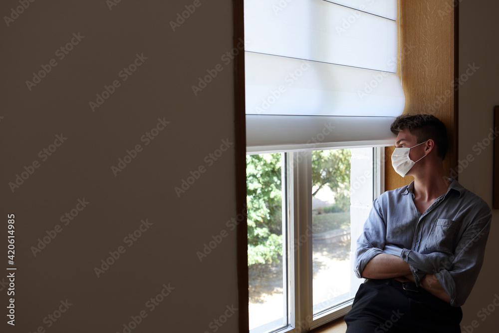Young man indoors with protective facial mask Young man indoors with protective facial mask