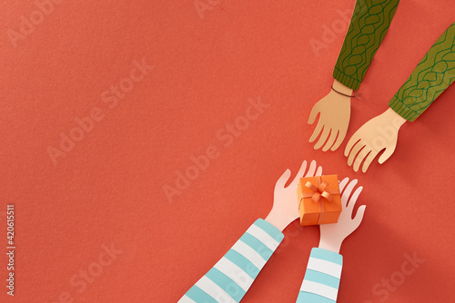 Hands giving and receiving a present photo