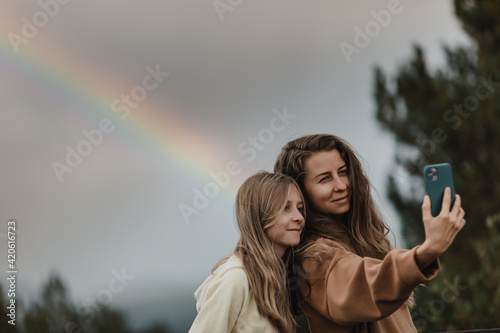 mother and daughter taking selfie. photo