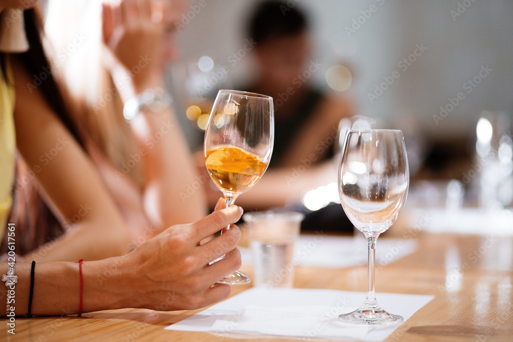 Crop woman with wine sitting at table Crop woman with wine sitting at table