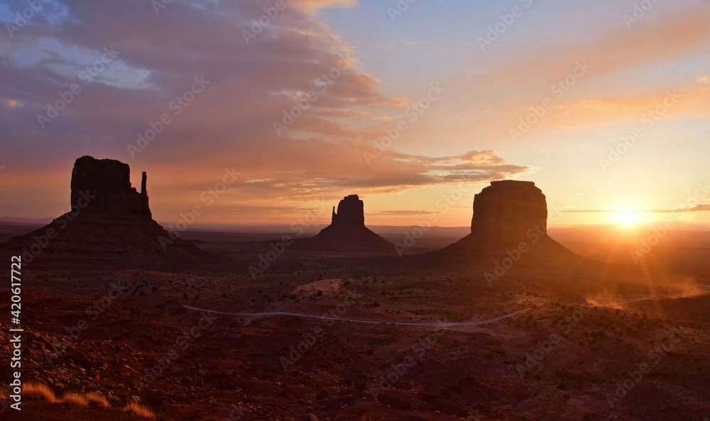 sunset in winter behind the spectacular mitten buttes and merrick butte from  the view hotel in  the navajo tribal park of monument valley, utah 