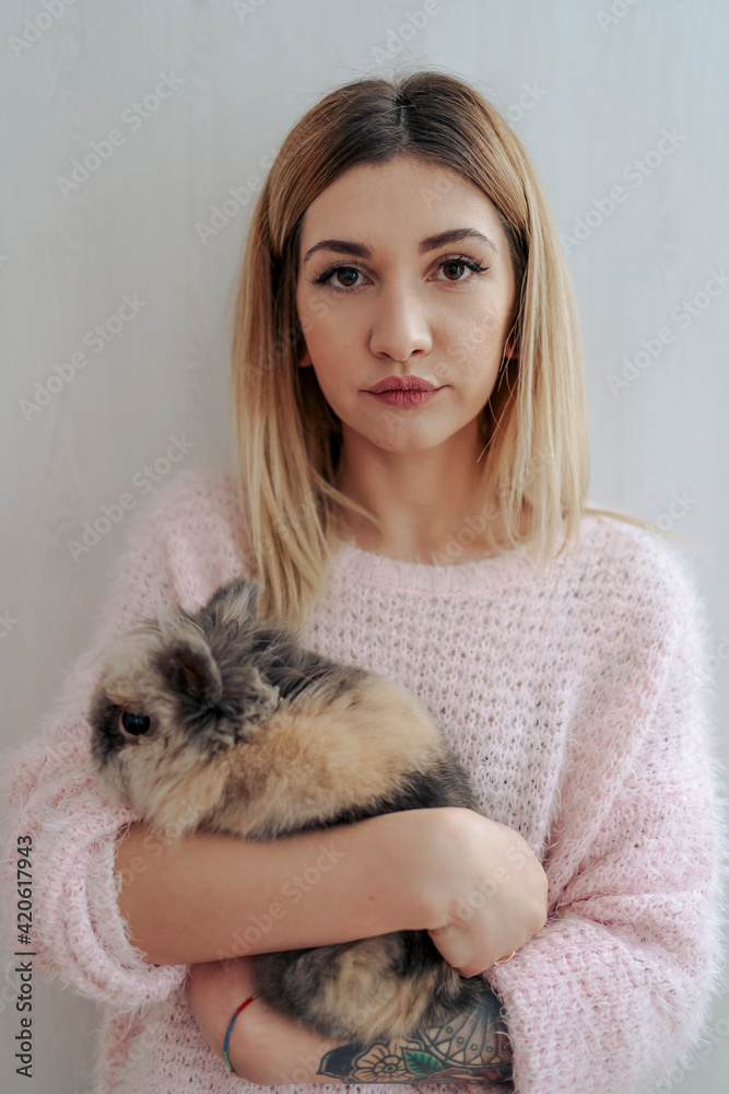 Woman at home with her cute rabbit Woman at home with her cute rabbit