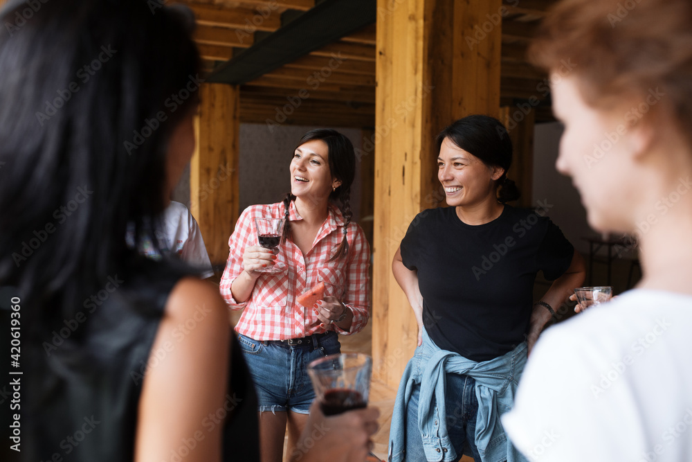 Happy women chatting during wine tasting in cellar Happy women chatting during wine tasting in cellar