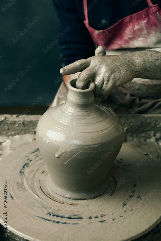 Ceramist, man's hands working on clay Ceramist, man's hands working on clay