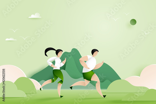 Male and Female running in nature mountain landscape.Marathon or Trail running sport activity.