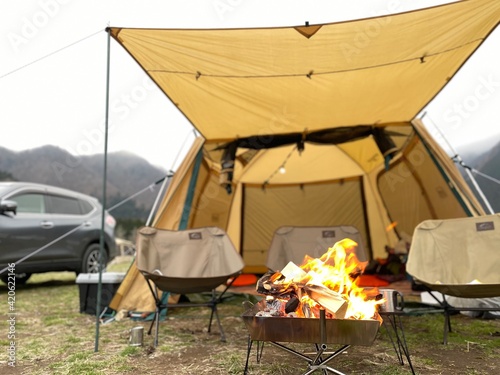 テントとアウトドアチェアと焚き火 photo