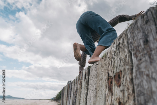 Anonymous Back Woman Climbing a Fence photo