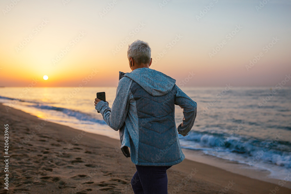Unrecognizable sportswoman running on beach Unrecognizable sportswoman running on beach