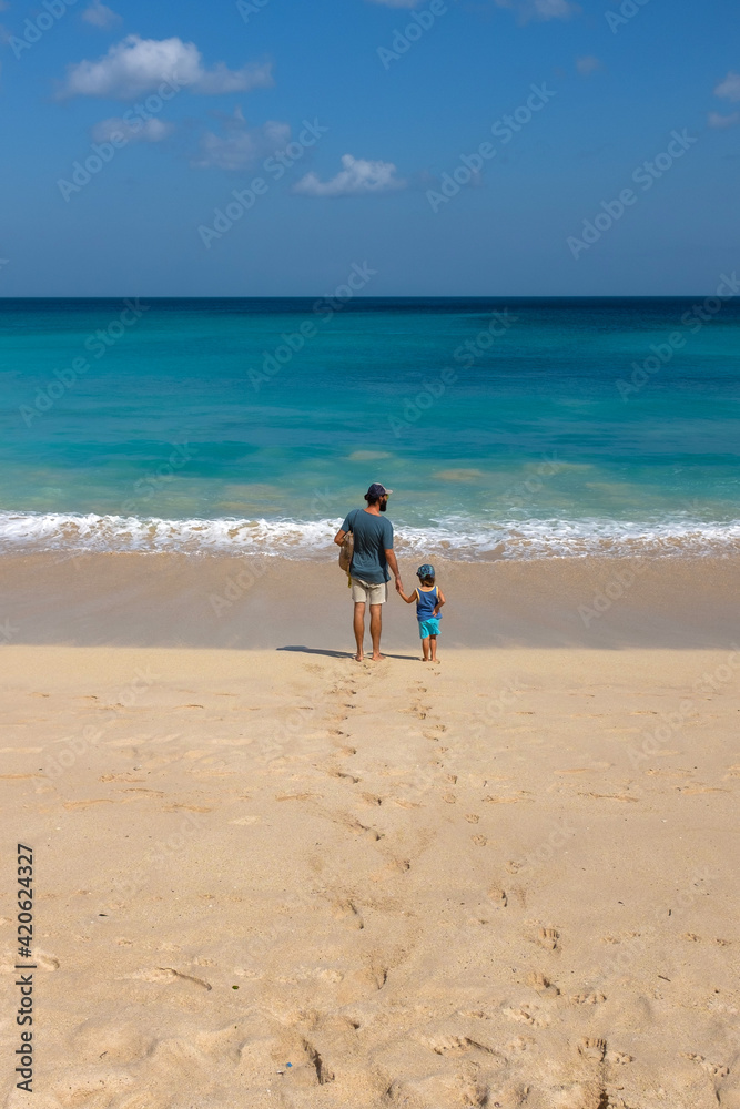 Father and son by the beautiful surface of the ocean Father and son by the beautiful surface of the ocean