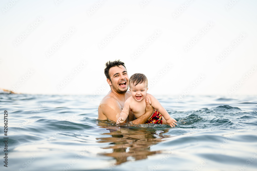 Father swimming with his son.
