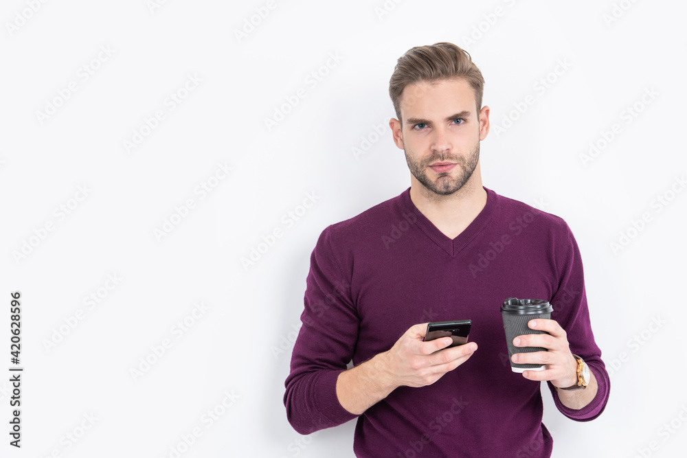 Caffeine and smartphone addiction. Handsome man use phone drinking coffee. Addiction to technology Caffeine and smartphone addiction. Handsome man use phone drinking coffee. Addiction to technology