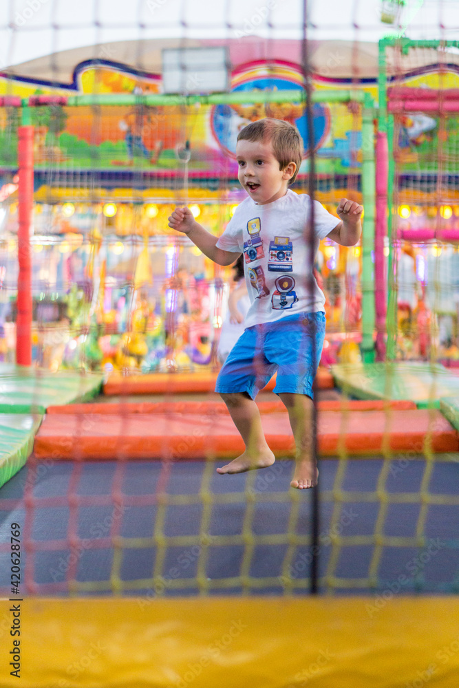 Kid jumping on a trampoline at the carnival Kid jumping on a trampoline at the carnival