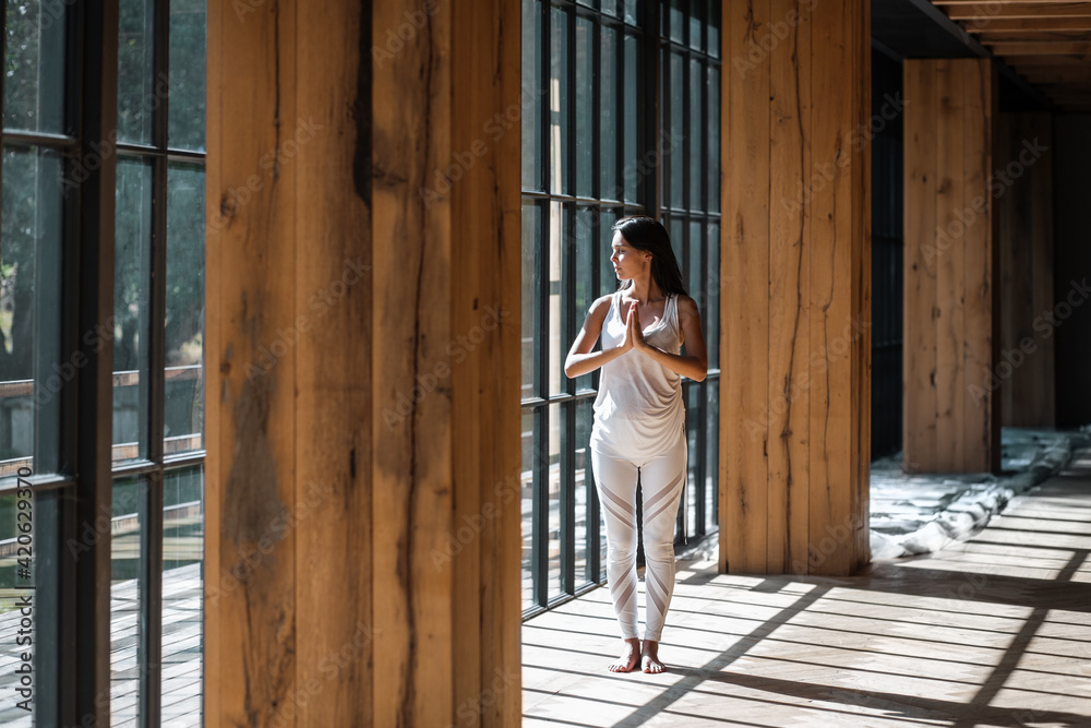 Woman with clasped hands standing near window Woman with clasped hands standing near window