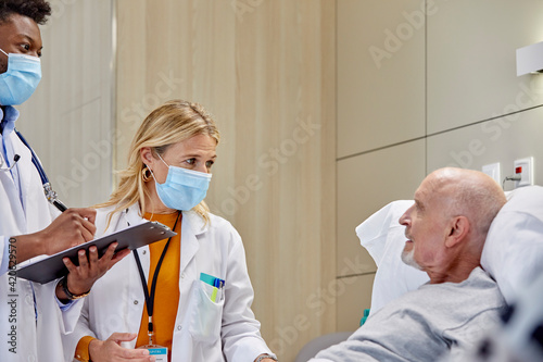 Doctors examining a senior patient