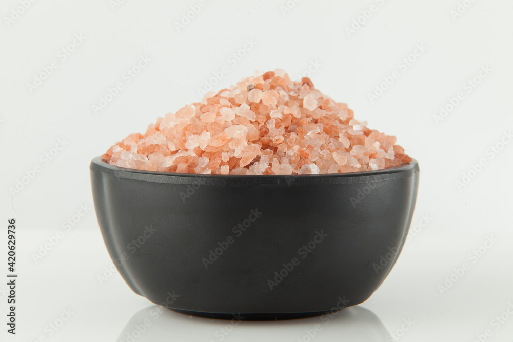 Pink salt from the Himalayas; photo on white background. Pink salt from the Himalayas; photo on white background.