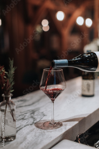 Wine Pouring into Wine Glass at Bar