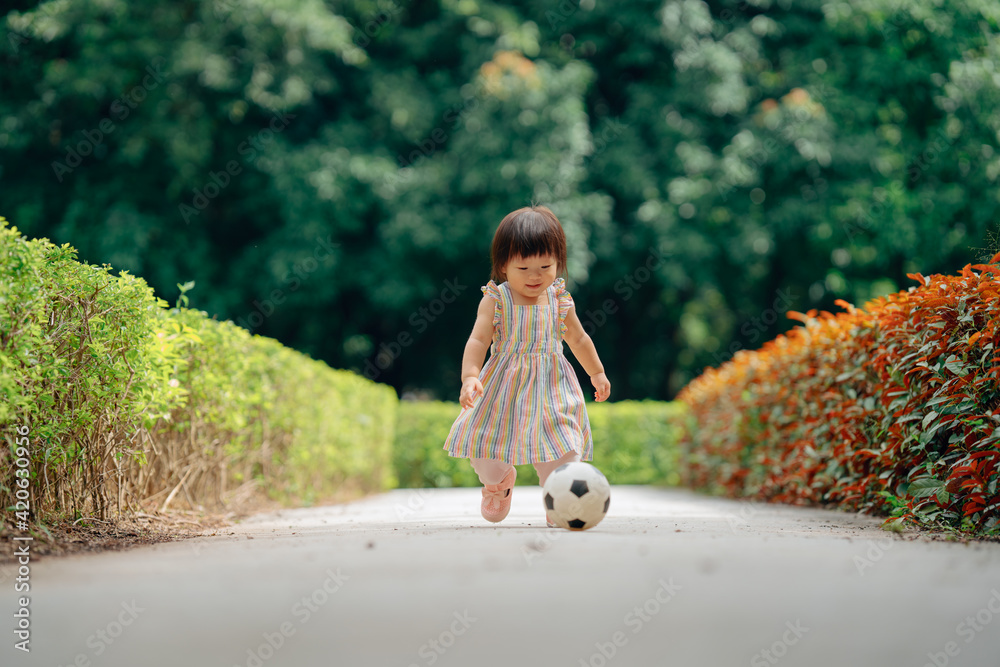Little girl playing football outdoors Stock Photo Adobe Stock