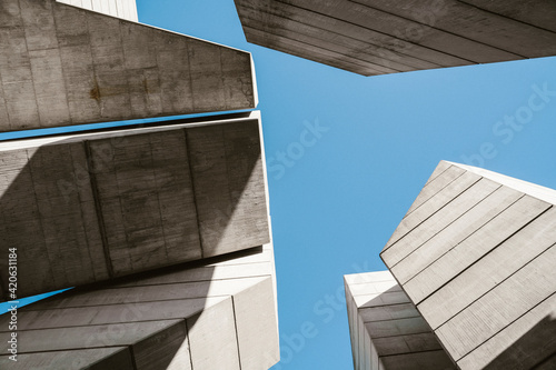 Minimal concrete geometrical architectural structures against blue sky photo