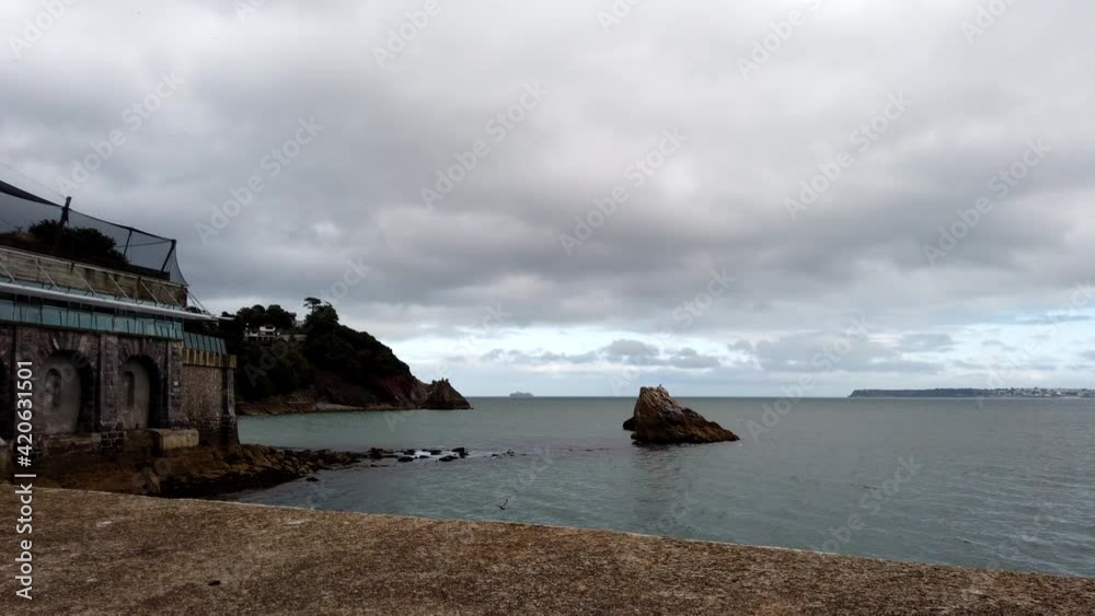 Time lapse shot showing ocean shore and moving dark clouds in Torquay,South Devon Time lapse shot showing ocean shore and moving dark clouds in Torquay,South Devon