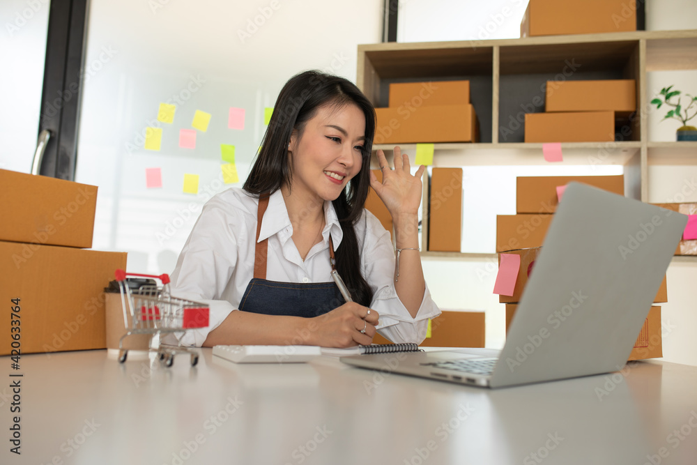 Startup small business SME, Entrepreneur owner working at home office and checking online purchase shopping order to preparing pack product box. Selling online ,Online Shopping ideas concept Startup small business SME, Entrepreneur owner working at home office and checking online purchase shopping order to preparing pack product box. Selling online ,Online Shopping ideas concept
