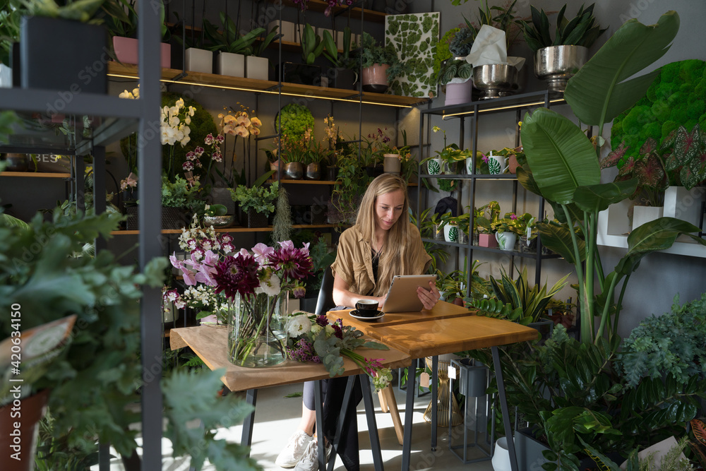 Florist Using Tablet At Flower Shop Florist Using Tablet At Flower Shop