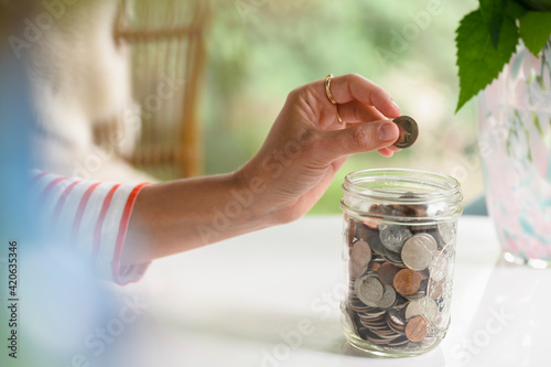 Putting a Coin in a Savings Jar