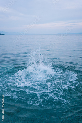 Foamy blue sea after a big jump photo