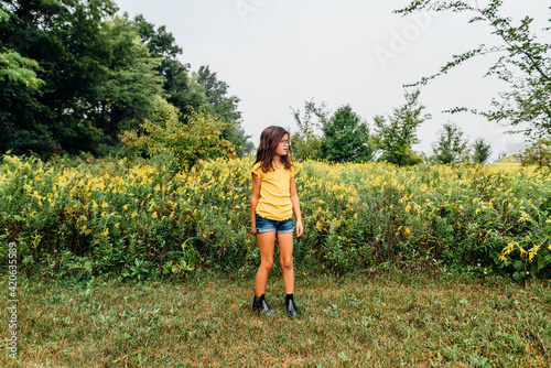 Portrait of 9 year old girl in a field of flowers. photo