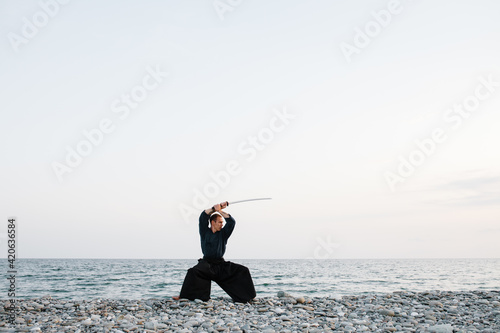Male warrior standing in fighting stance near sea
