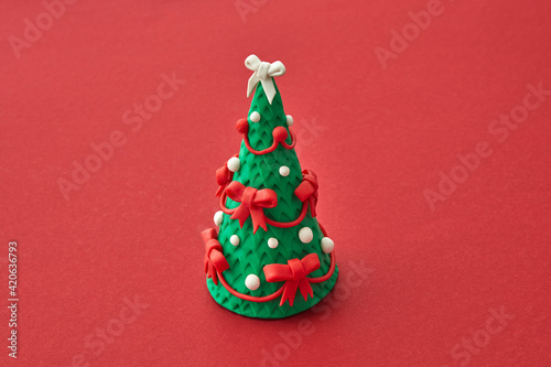 Handmade figure of Christmas tree from modeling clay. photo