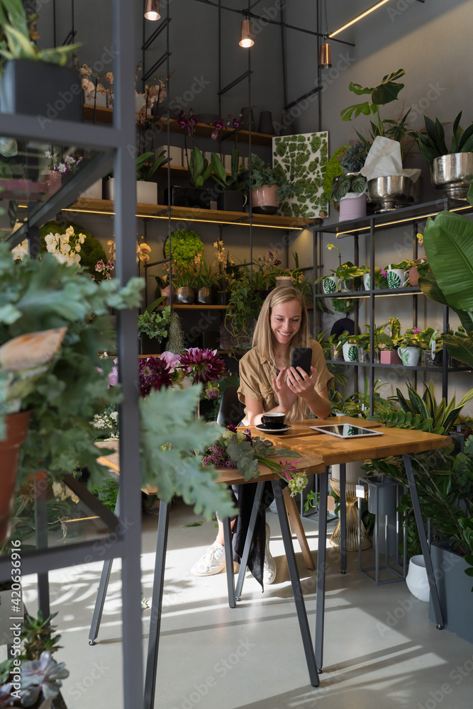 Florist Using Cellphone At Studio Florist Using Cellphone At Studio