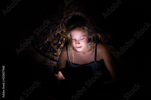 Woman Reads a Book Late at Night photo