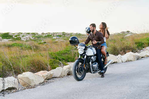 Couple sitting a motorbike ride in the country
