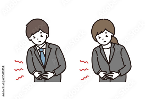 腹痛に悩むスーツ姿の若い男性と女性