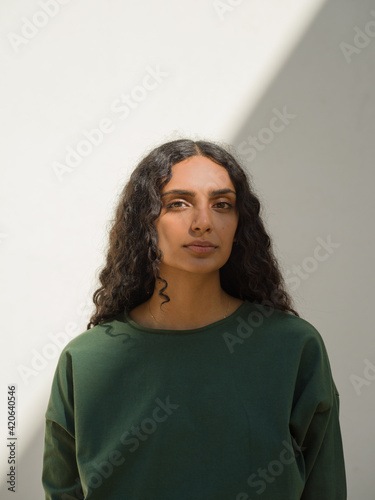 portrait of woman with diagonal shadow with white background photo