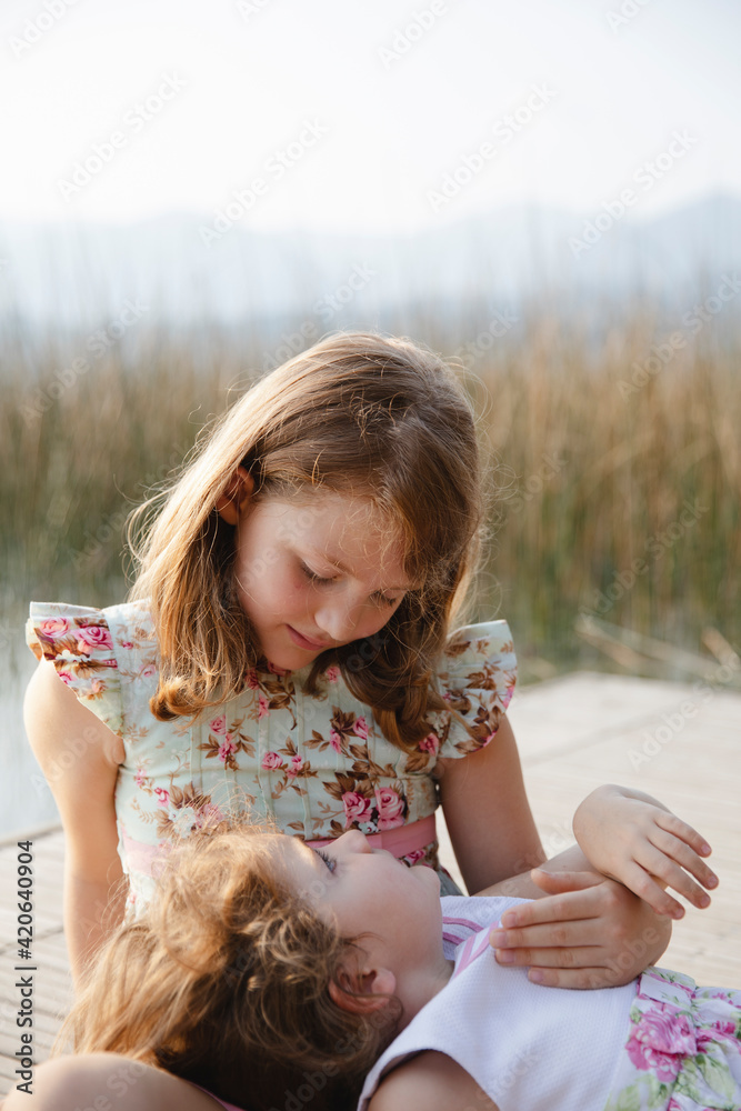 Big sister takes care of her younger sister Big sister takes care of her younger sister