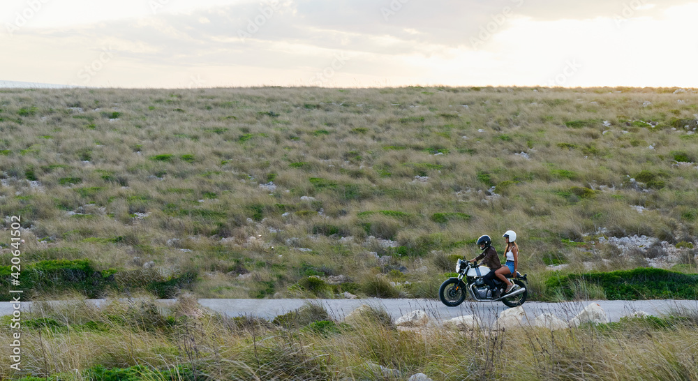 Couple riding in the country a motorbike Couple riding in the country a motorbike