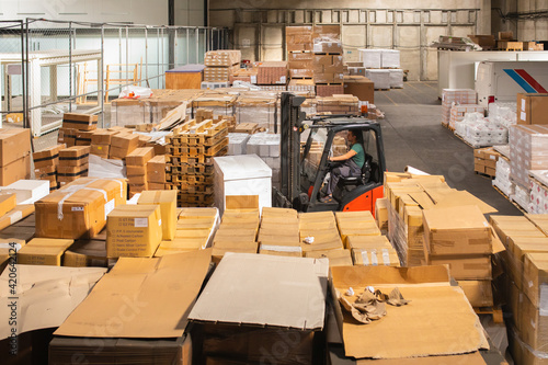 The worker transports freight using a forklift photo
