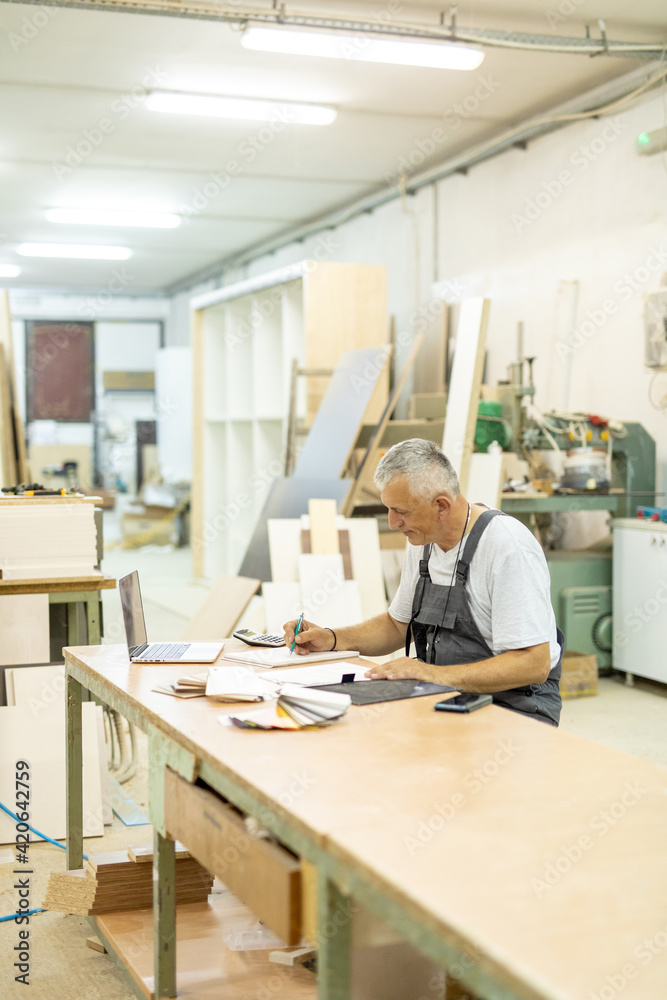 Carpenter working in a workshop Carpenter working in a workshop