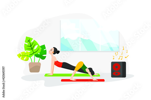 A woman and her daughter do yoga lesson next at home to a speaker playing relaxing music 