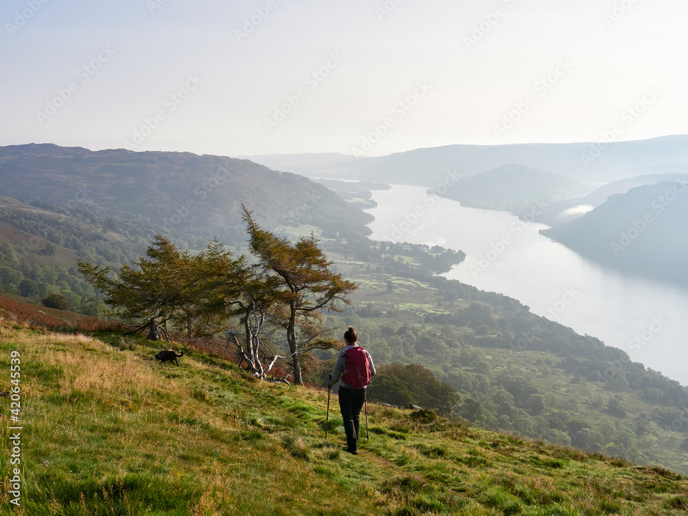 Female walker descending from Hart Side to Ullswater. Lake District, UK.