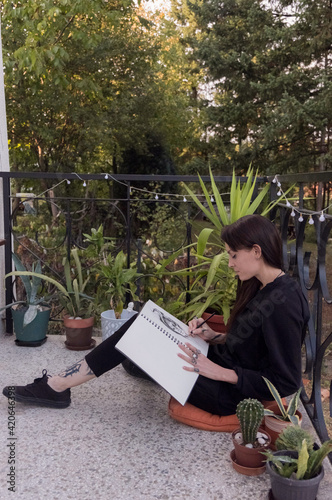 Woman drawing some science fiction sketch photo