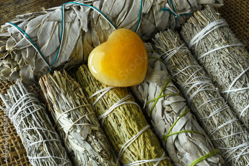 Fotografie A top view image of several healing sage smudge sticks bundles.