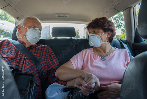 Senior Couple Wearing Masks In The Car photo