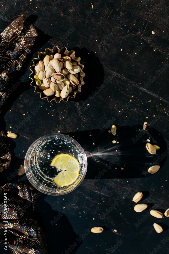Eating pistachios and drinking lemon water Stock Photo Adobe Stock